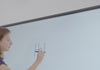 Teacher demonstrating writing naturally on Nework E Series smart board with ultra-low latency and AI handwriting recognition
